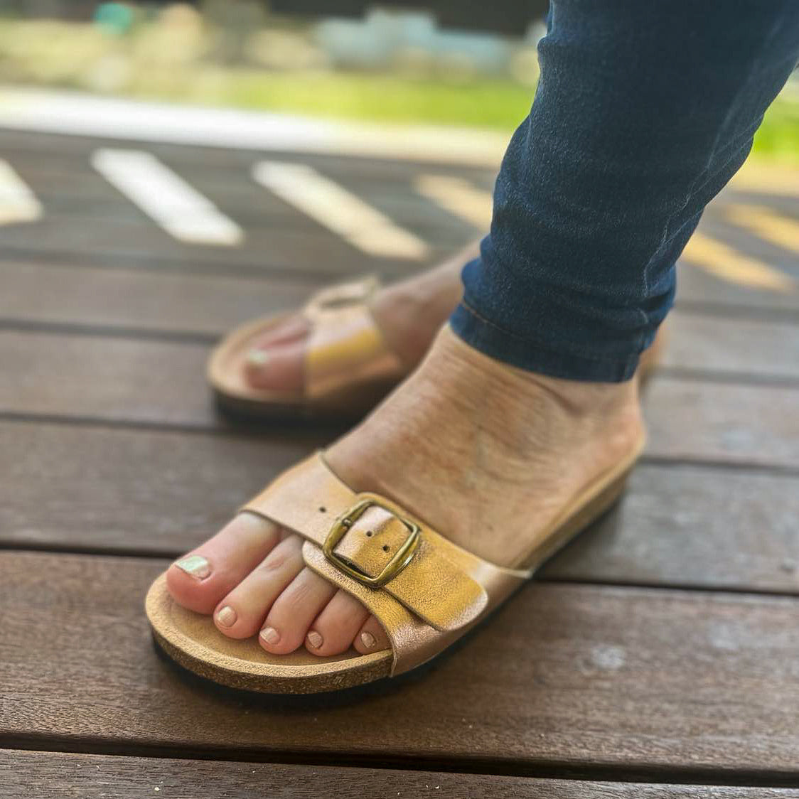 wearing-rose-gold-leather-sandals-side-view